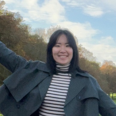 Photograph of Yujin Kim happily posing and stretching out her right arm into the air on The Long Walk leading to Windsor Castle, UK.