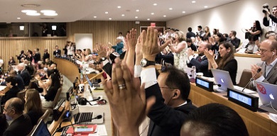 People in a conference room applauding enthusiastically