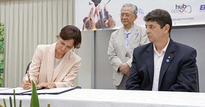 A man and a woman sitting at a desk.