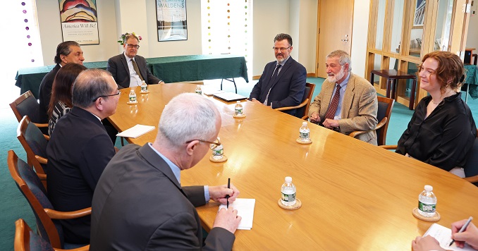 People seated around a table in conversation.