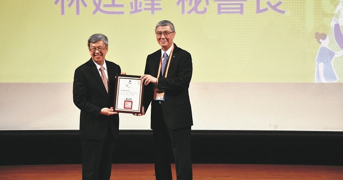 Two men holding an award together.