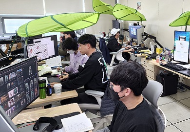 People sitting in an office at their desks.