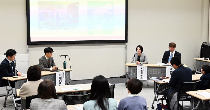 Speakers and participants gathered at a conference room