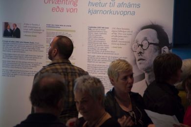 A man reads a large exhibition panel