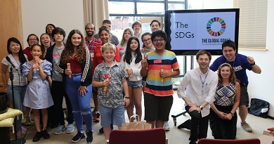 Group photo of children in front of an SDG sign