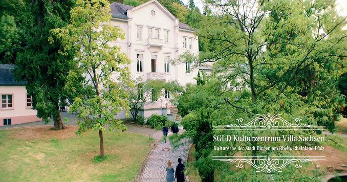 Picture of a large white villa among trees